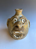 # 13 Terry King Face Jug Buggy Jug 7"